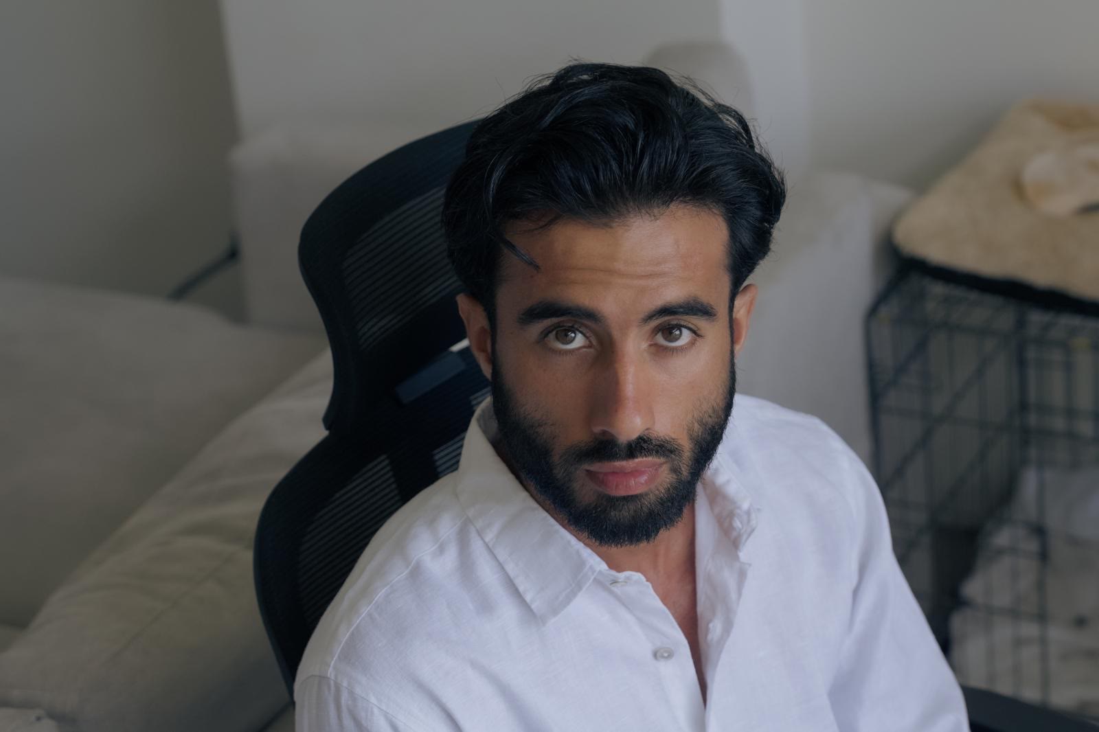 Suroesh Jazayeri, close portrait in a white shirt.